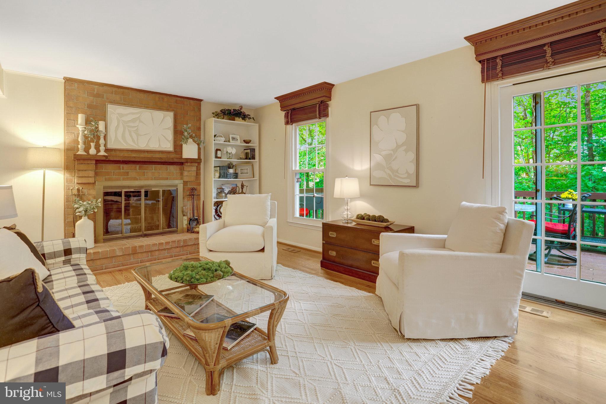 7006 Maple Tree Lane Springfield, VA 22152 - Photo 16 of 49 a living room with furniture a fireplace and a floor to ceiling window