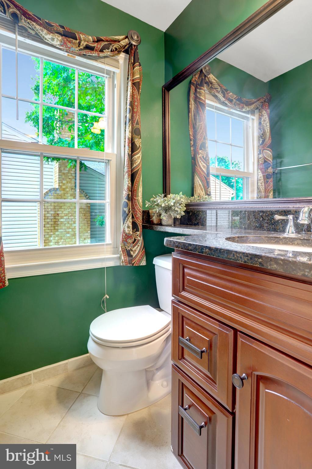 7006 Maple Tree Lane Springfield, VA 22152 - Photo 19 of 49 a bathroom with a toilet sink and mirror