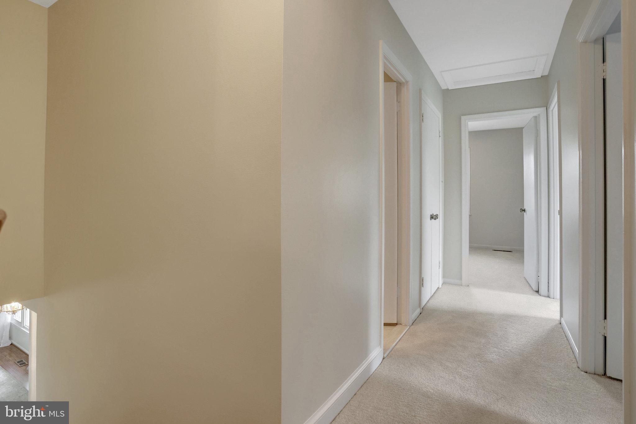7006 Maple Tree Lane Springfield, VA 22152 - Photo 21 of 49 a view of a hallway with a wooden cabinets
