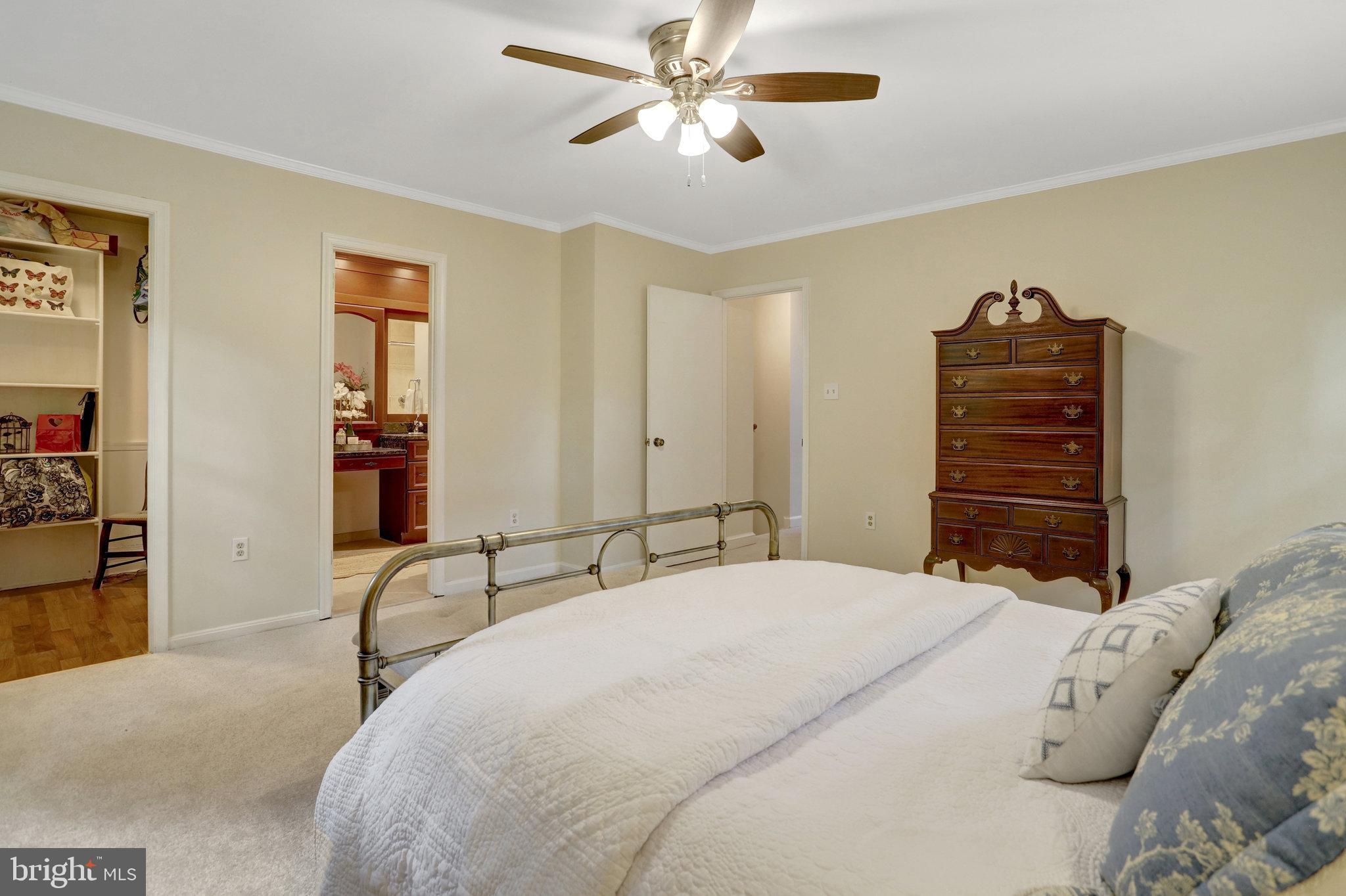 7006 Maple Tree Lane Springfield, VA 22152 - Photo 23 of 49 a bedroom with a bed and a chandelier