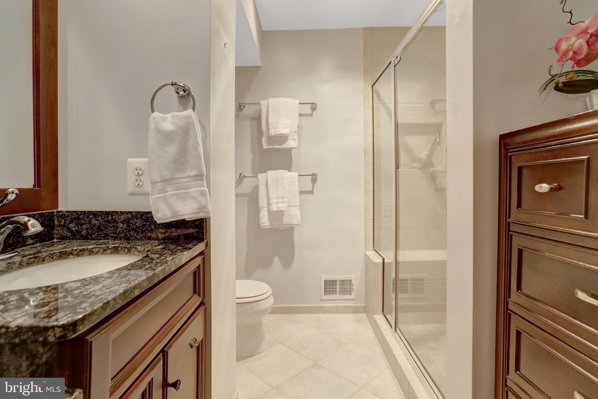 7006 Maple Tree Lane Springfield, VA 22152 - Photo 25 of 49 a bathroom with a granite countertop sink toilet and shower