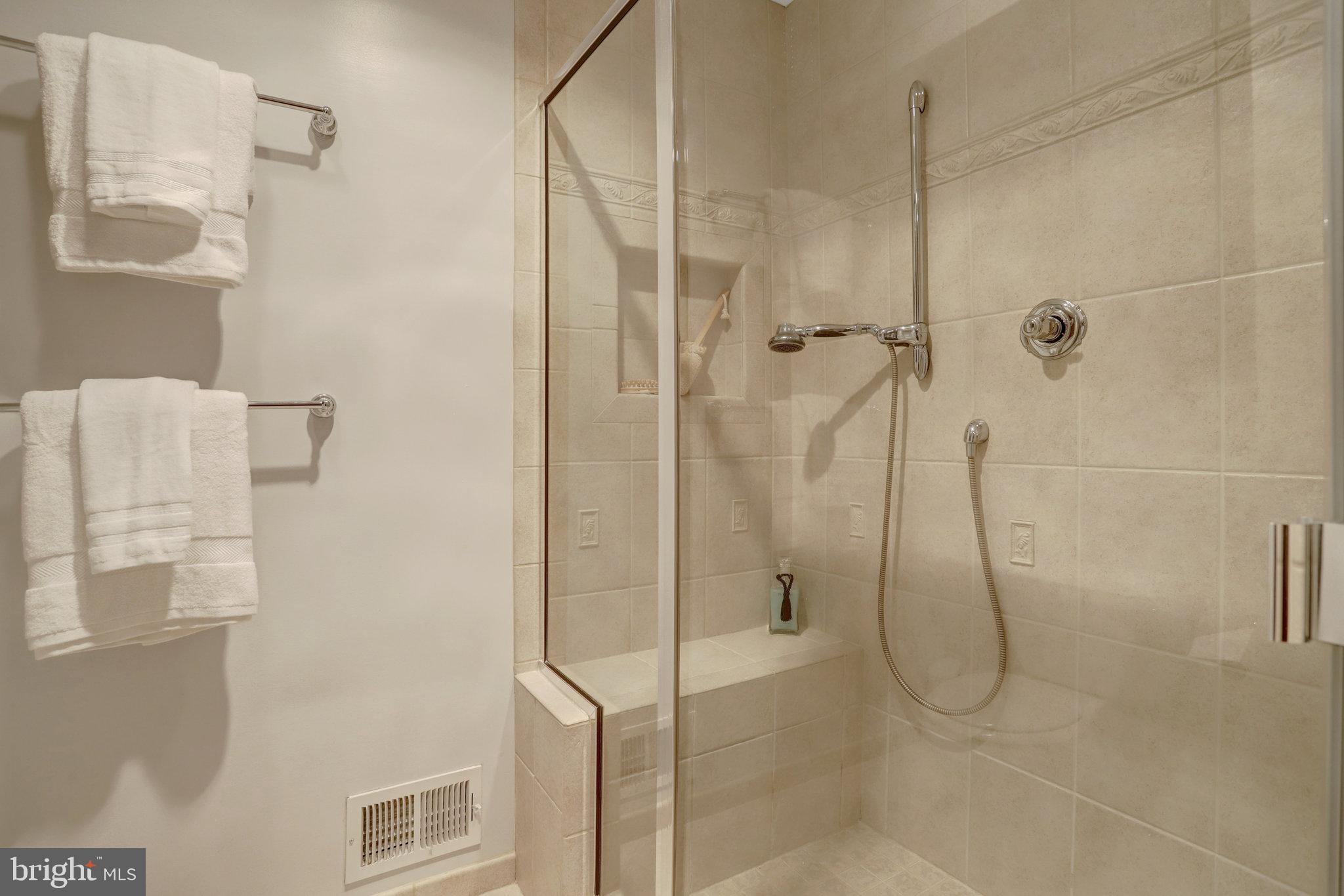 7006 Maple Tree Lane Springfield, VA 22152 - Photo 26 of 49 a bathroom with a glass shower door
