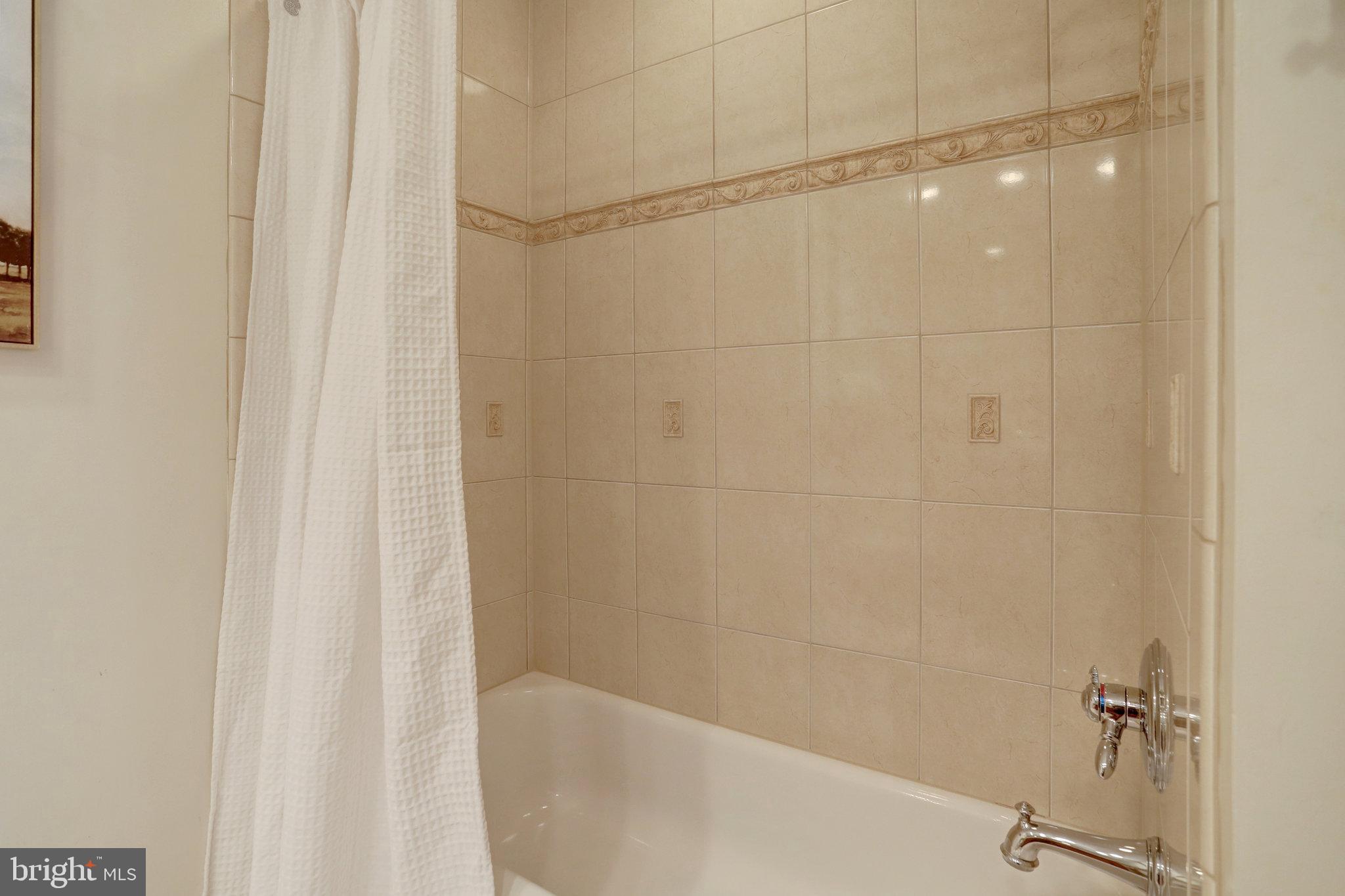 7006 Maple Tree Lane Springfield, VA 22152 - Photo 28 of 49 a bathroom with a shower and a tub