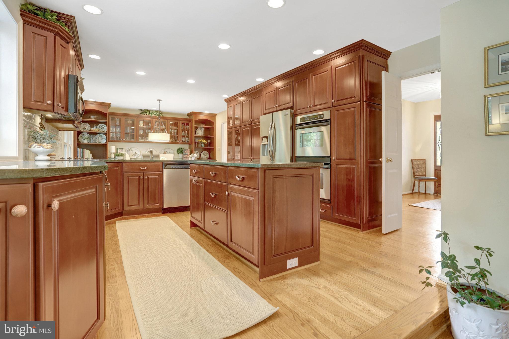 7006 Maple Tree Lane Springfield, VA 22152 - Photo 3 of 49 a kitchen with stainless steel appliances granite countertop a refrigerator and stove