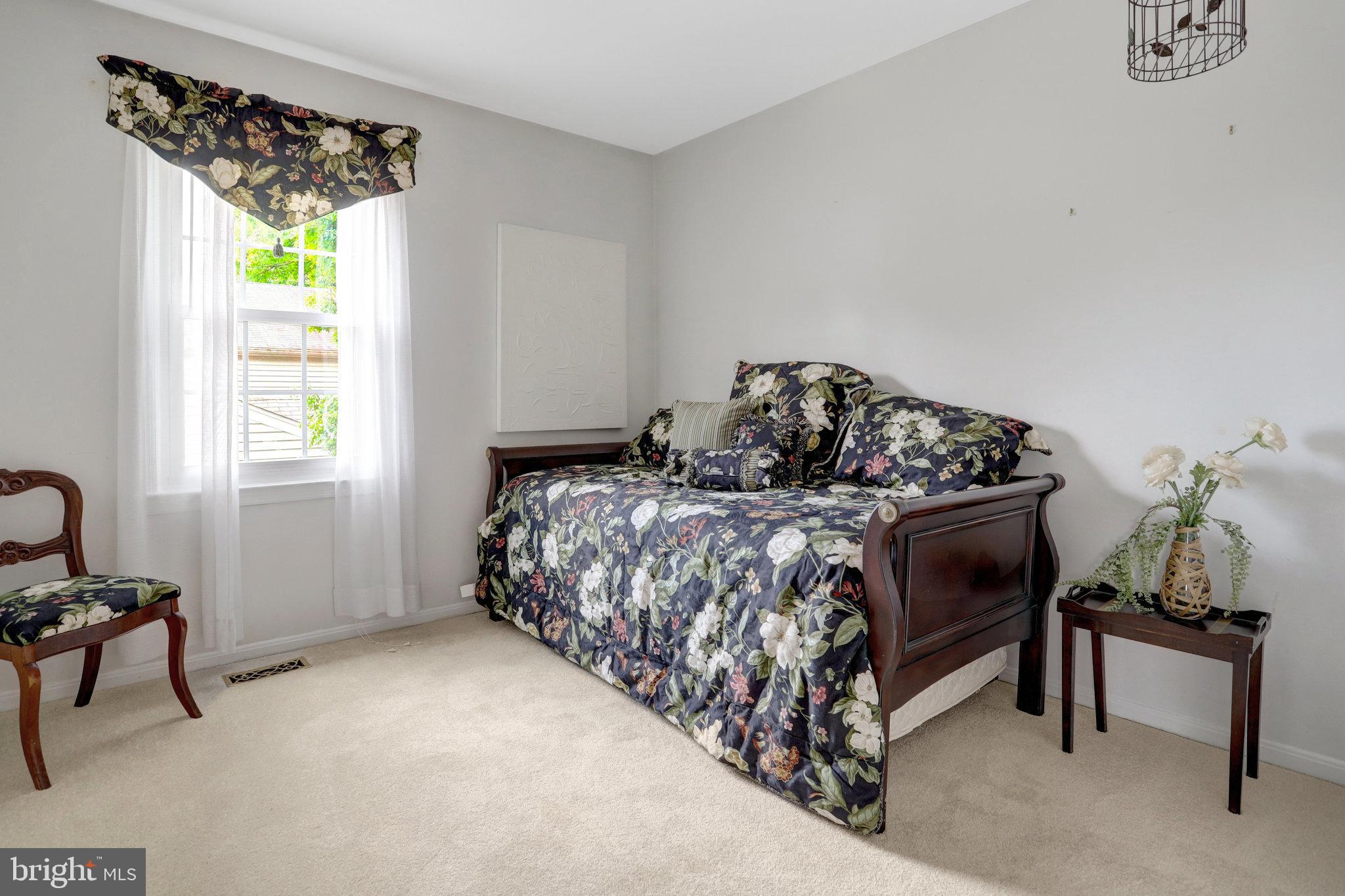 7006 Maple Tree Lane Springfield, VA 22152 - Photo 32 of 49 a bed sitting in a bedroom next to a window