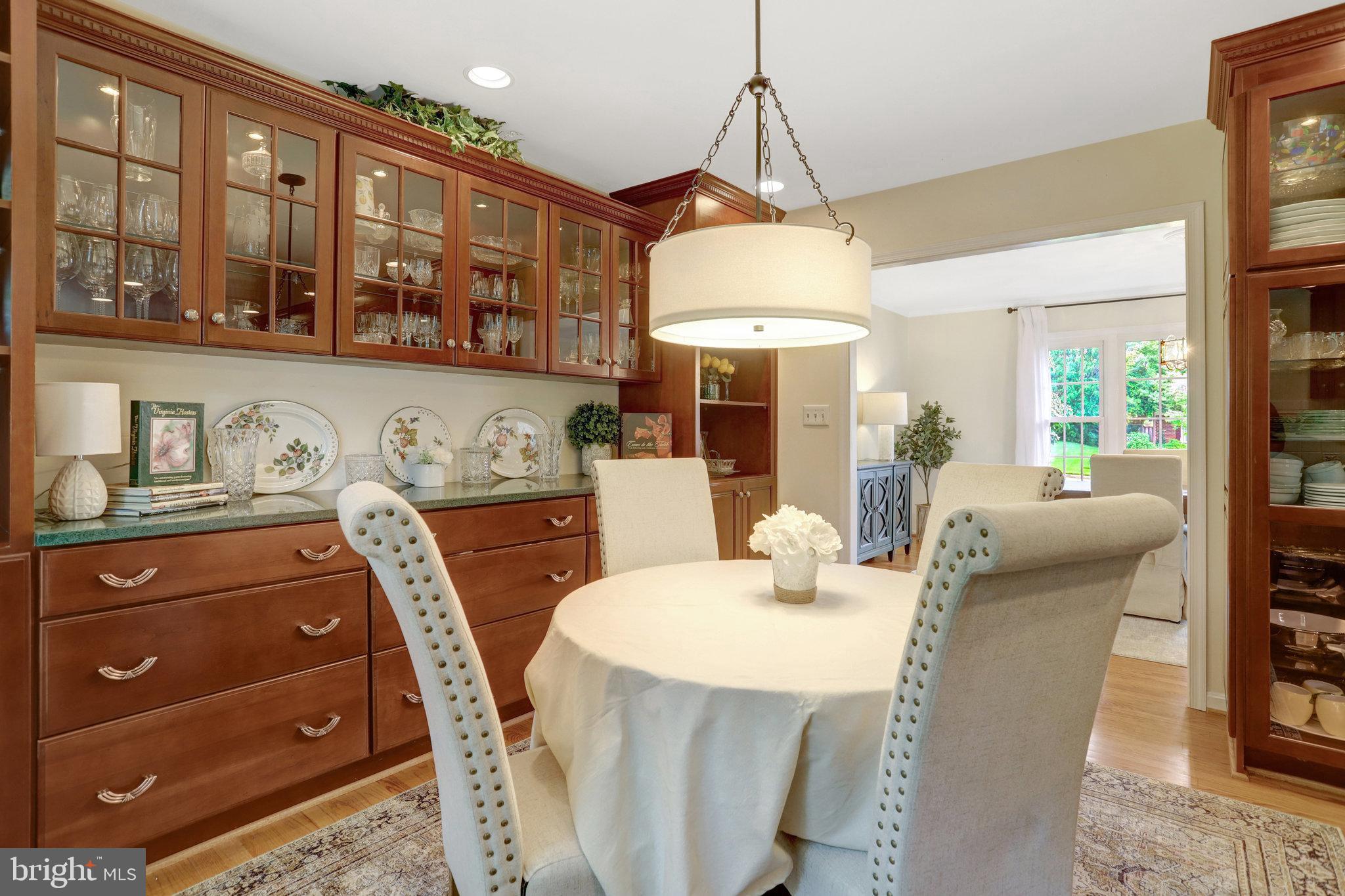 7006 Maple Tree Lane Springfield, VA 22152 - Photo 8 of 49 a dining room with furniture a chandelier and window