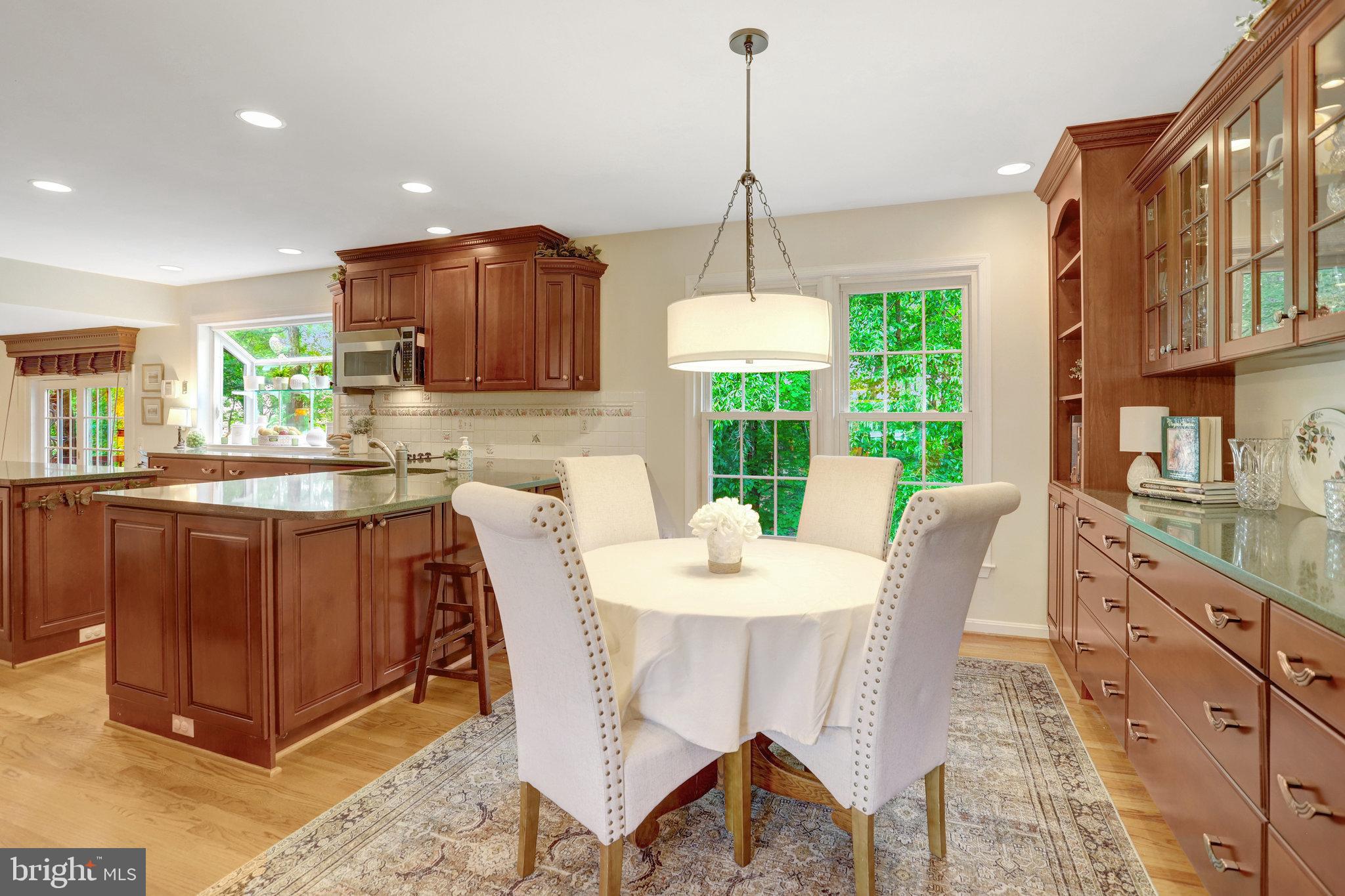 7006 Maple Tree Lane Springfield, VA 22152 - Photo 9 of 49 a kitchen with stainless steel appliances granite countertop a stove top oven a sink a counter top space and cabinets