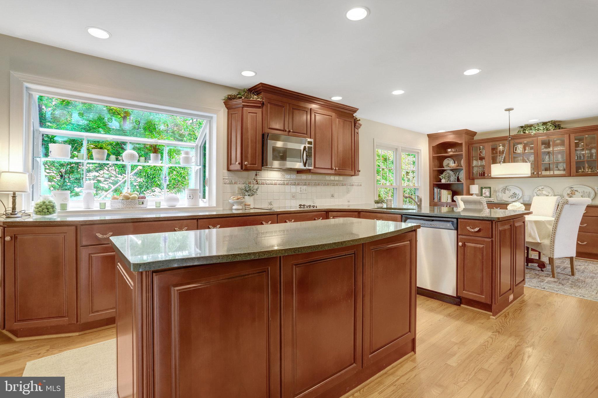 7006 Maple Tree Lane Springfield, VA 22152 - Photo 10 of 49 a kitchen with stainless steel appliances granite countertop a sink and a stove