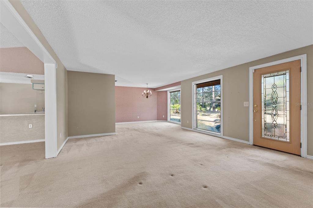 27814 Quail View Lane Wesley Chapel, FL 33544 - Photo 11 of 26 a view of a big room with windows and chandelier fan