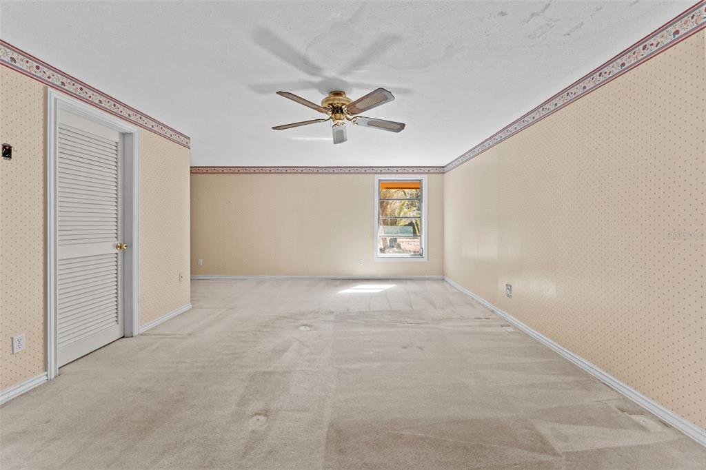 27814 Quail View Lane Wesley Chapel, FL 33544 - Photo 15 of 26 an empty room with windows and fan