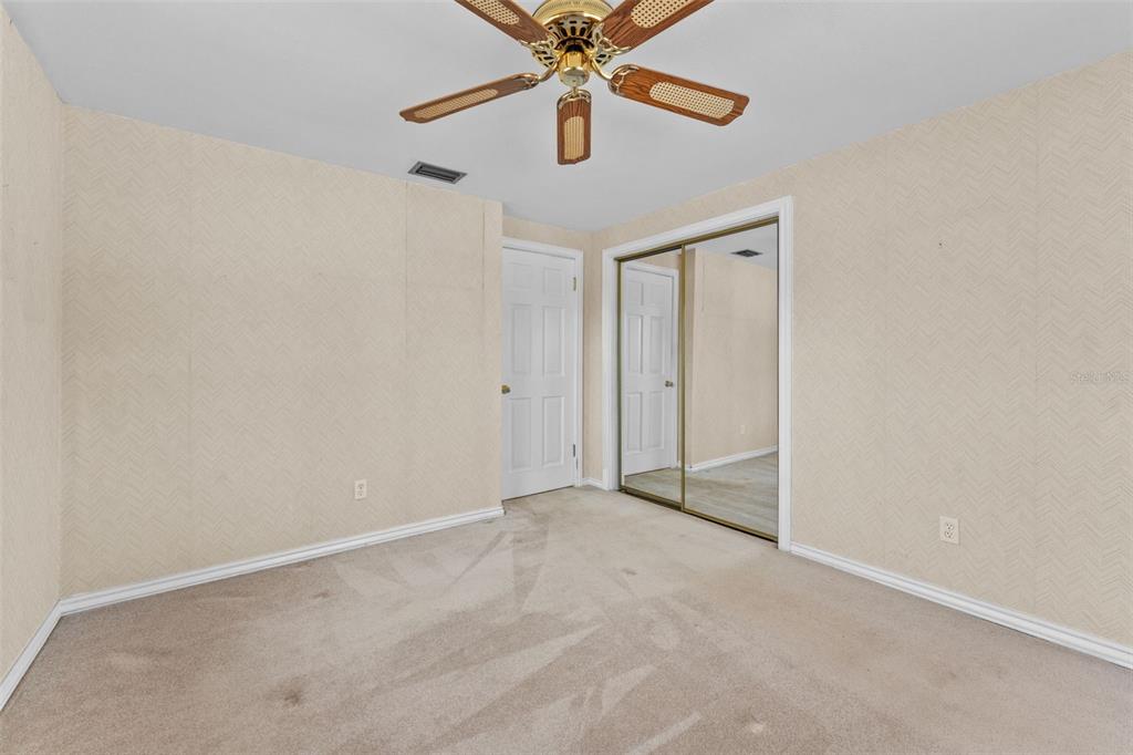 27814 Quail View Lane Wesley Chapel, FL 33544 - Photo 18 of 26 an empty room with closet and a chandelier fan
