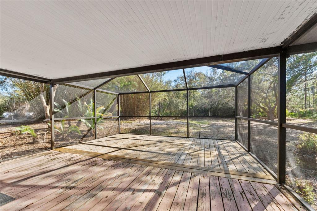 27814 Quail View Lane Wesley Chapel, FL 33544 - Photo 21 of 26 a view of an empty room with wooden floor and windows