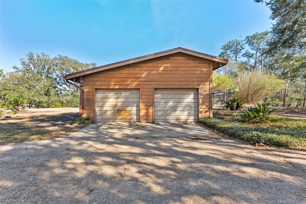27814 Quail View Lane Wesley Chapel, FL 33544 - Photo 23 of 26 a front view of a house with a yard and garage