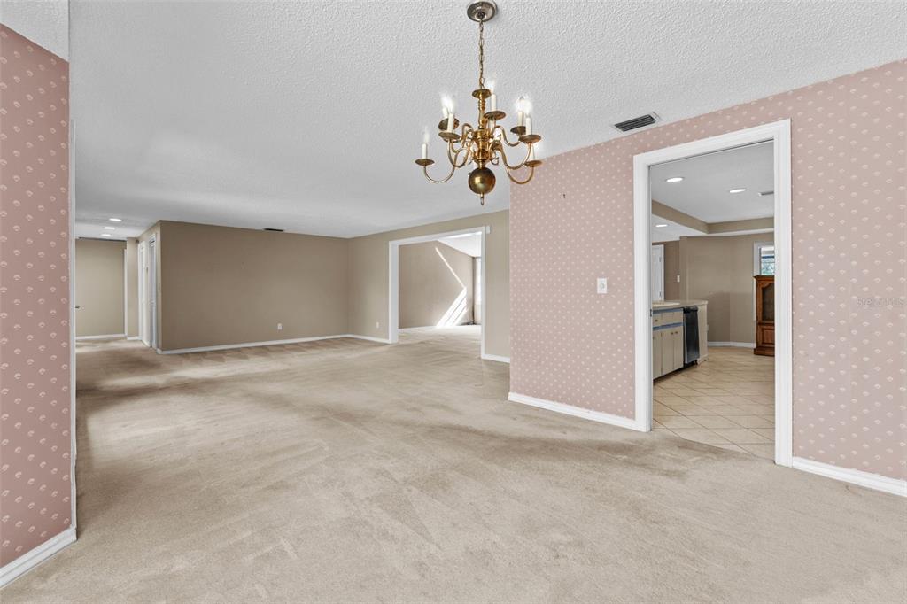 27814 Quail View Lane Wesley Chapel, FL 33544 - Photo 9 of 26 wooden floor with chandelier and glass door