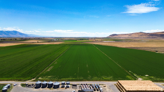 7220 West Cropley Road Tremonton, UT 84337 - Photo 10 of 23 Expansive agricultural fields with green crops, distant mountains, and a clear sky