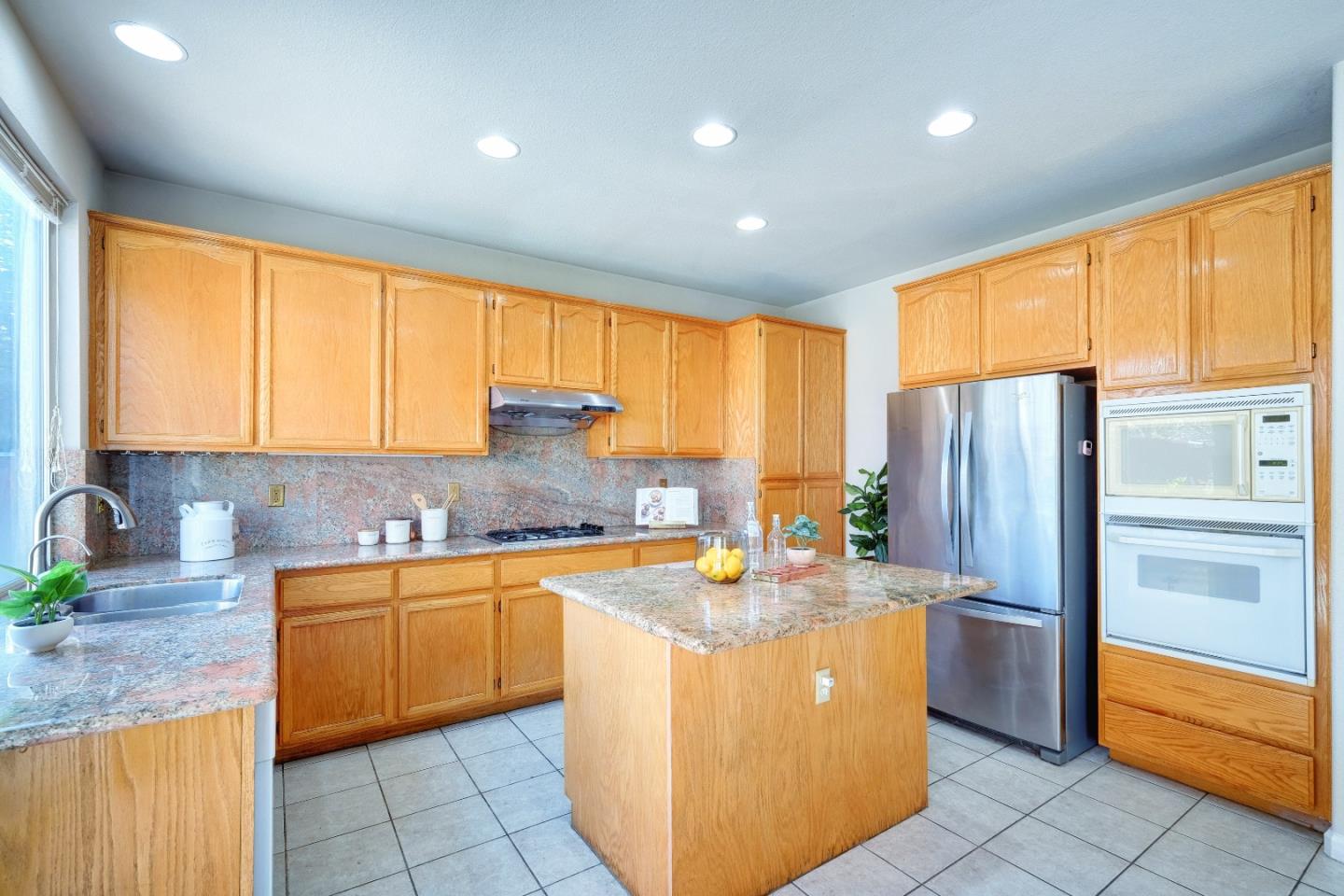 2194 Sierra Road San Jose, CA 95131 - Photo 11 of 45 a kitchen with stainless steel appliances granite countertop a sink a stove and a refrigerator