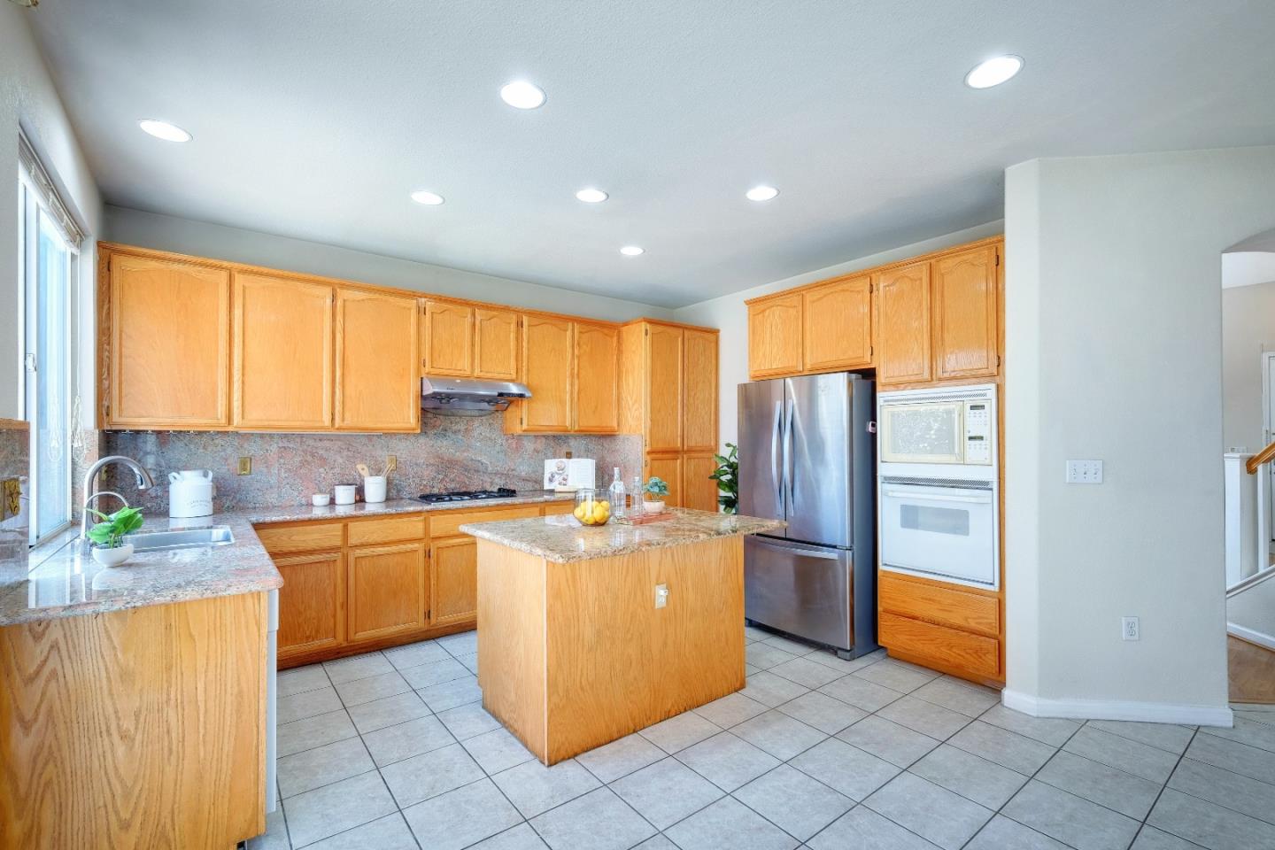2194 Sierra Road San Jose, CA 95131 - Photo 12 of 45 a kitchen with stainless steel appliances granite countertop a refrigerator a stove a sink and a microwave