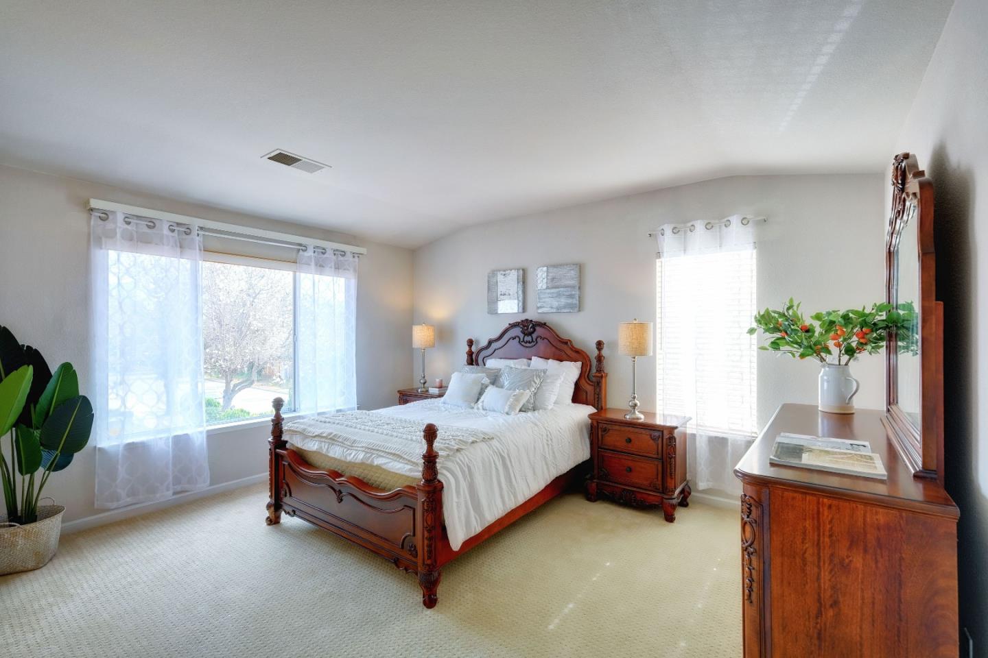 2194 Sierra Road San Jose, CA 95131 - Photo 21 of 45 a spacious bedroom with a bed and a potted plant
