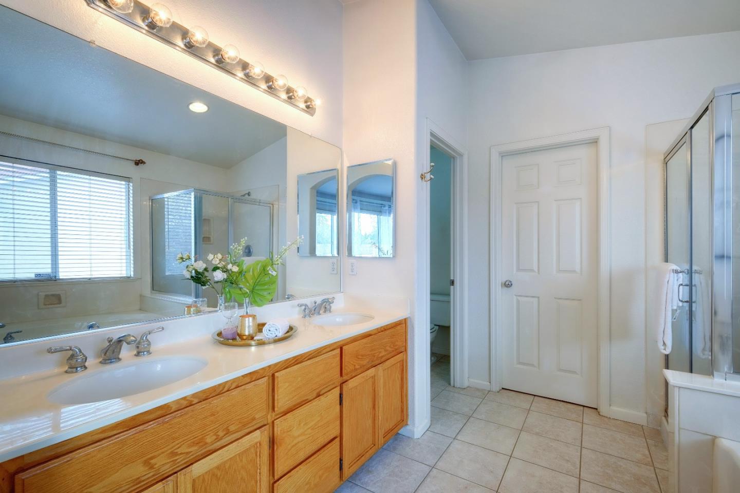 2194 Sierra Road San Jose, CA 95131 - Photo 25 of 45 a bathroom with a double vanity sink and a mirror