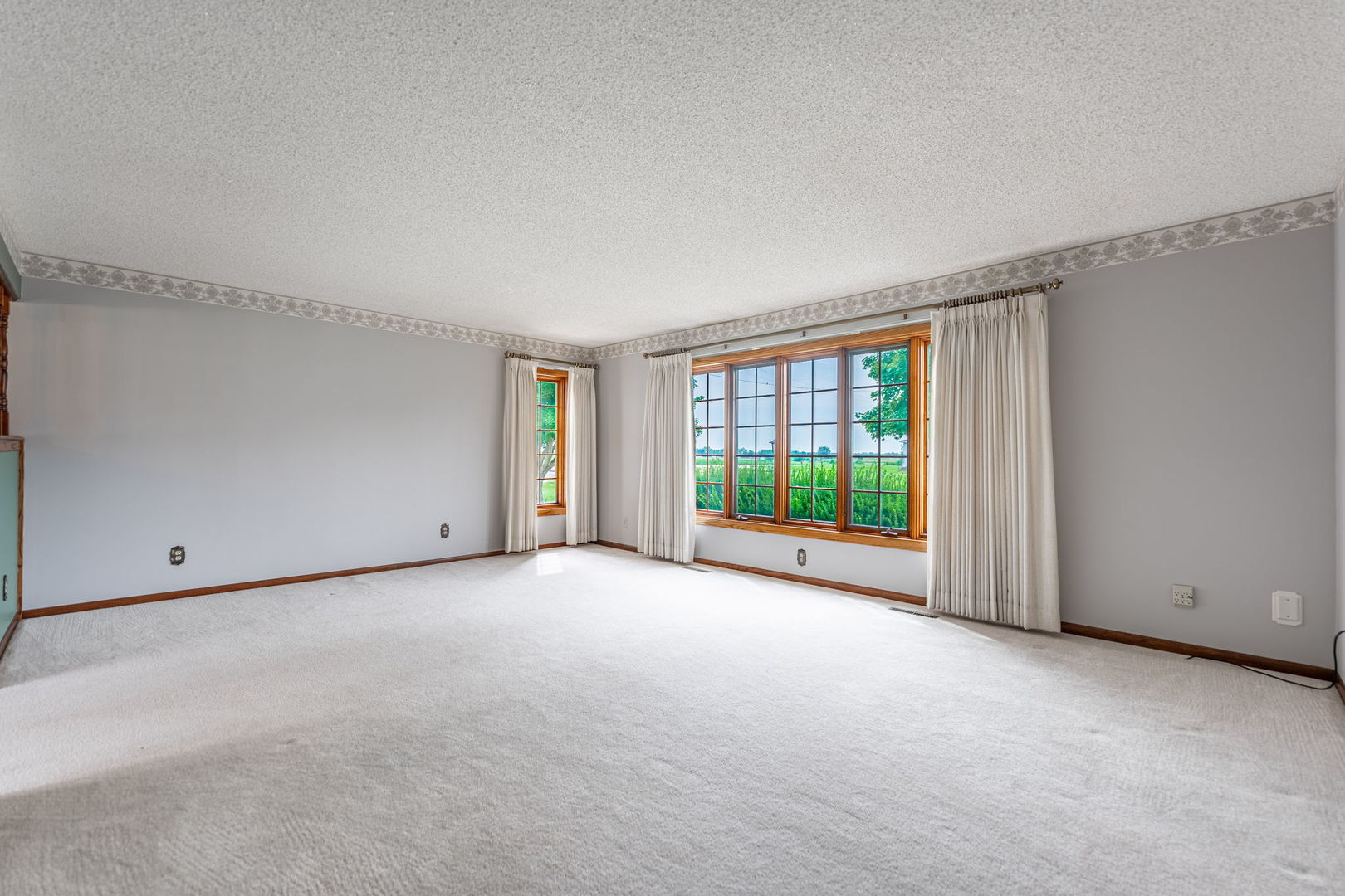 17955 Hillside Road Morrison, IL 61270 - Photo 3 of 40 a view of a big room with windows and chandelier fan