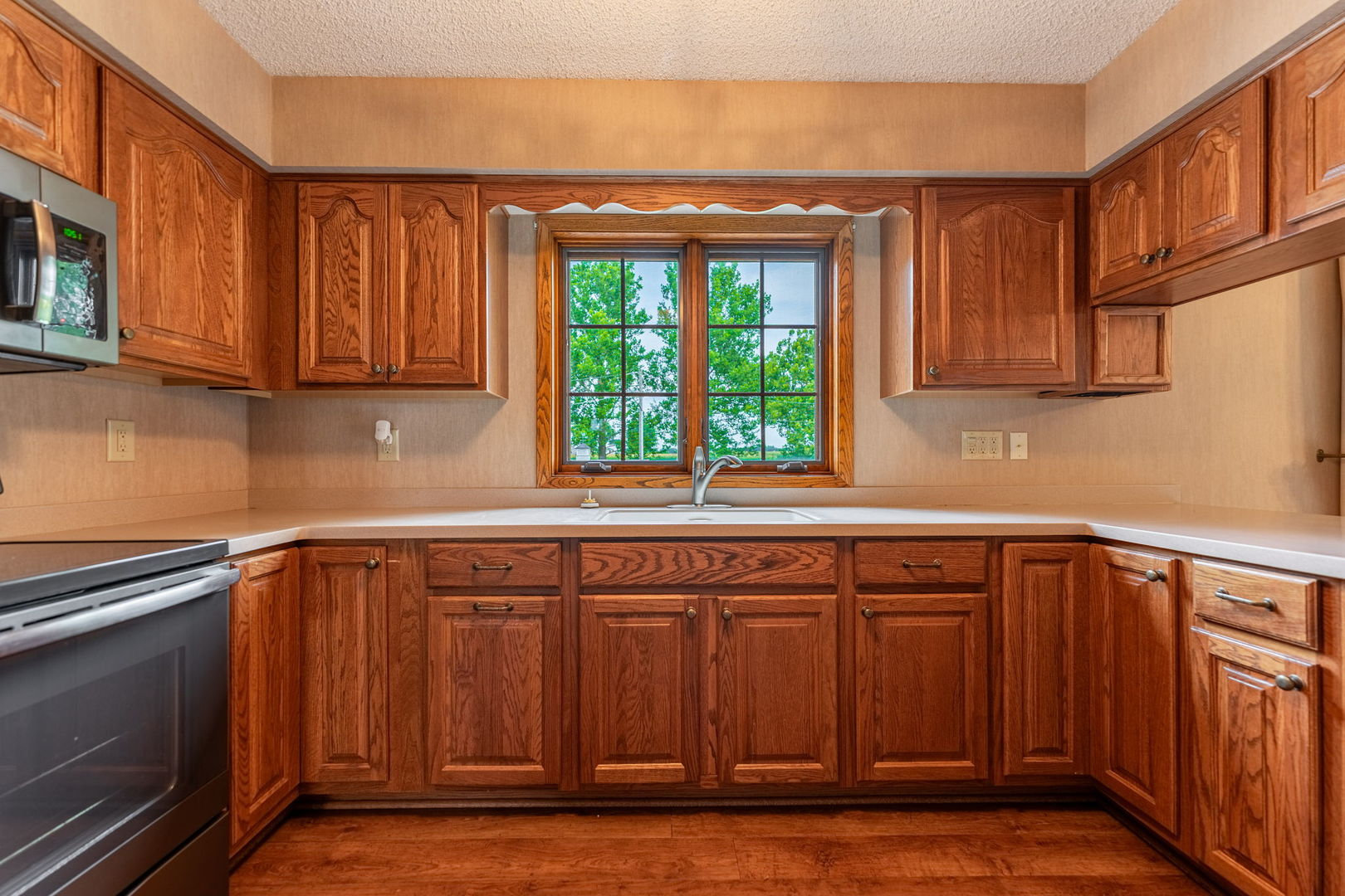 17955 Hillside Road Morrison, IL 61270 - Photo 8 of 40 a kitchen with stainless steel appliances granite countertop a refrigerator and wooden cabinets