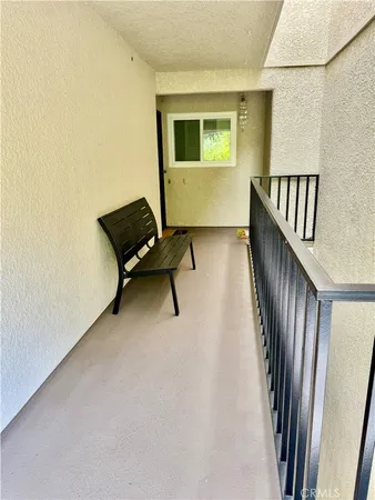 a view of a hallway with seating area
