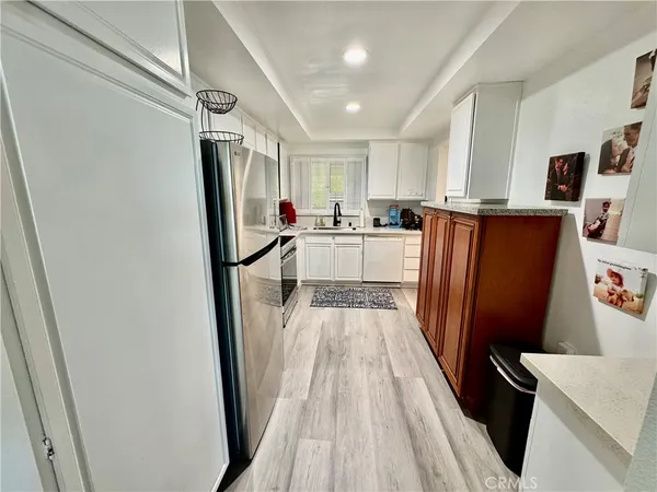 a kitchen with a sink appliances and cabinets