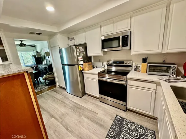 a kitchen with a sink appliances and cabinets