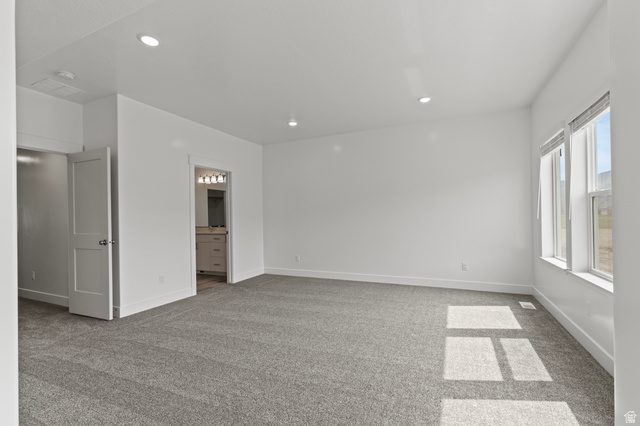 3410 South 1010th Street West Logan, UT 84321 - Photo 8 of 15 Unfurnished bedroom featuring light colored carpet, recessed lighting, and ensuite bathroom