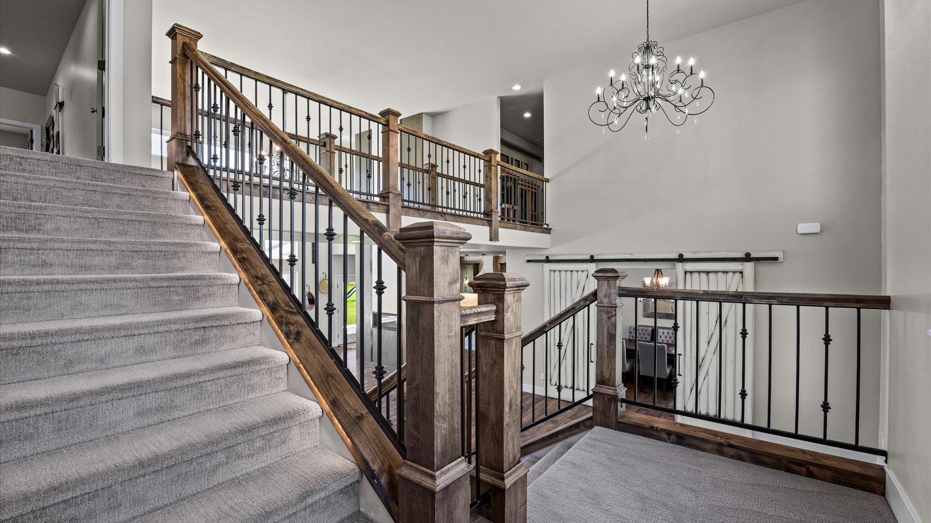 2041 J J 1/2 Road Fruita, CO 81521 - Photo 21 of 42 a view of staircase with railing and a chandelier