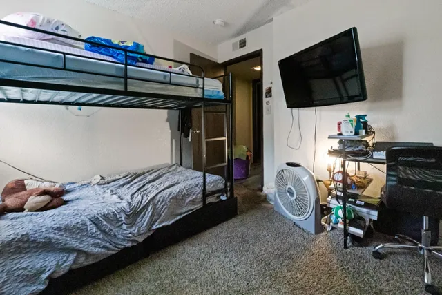 a bedroom with a bed and a dresser