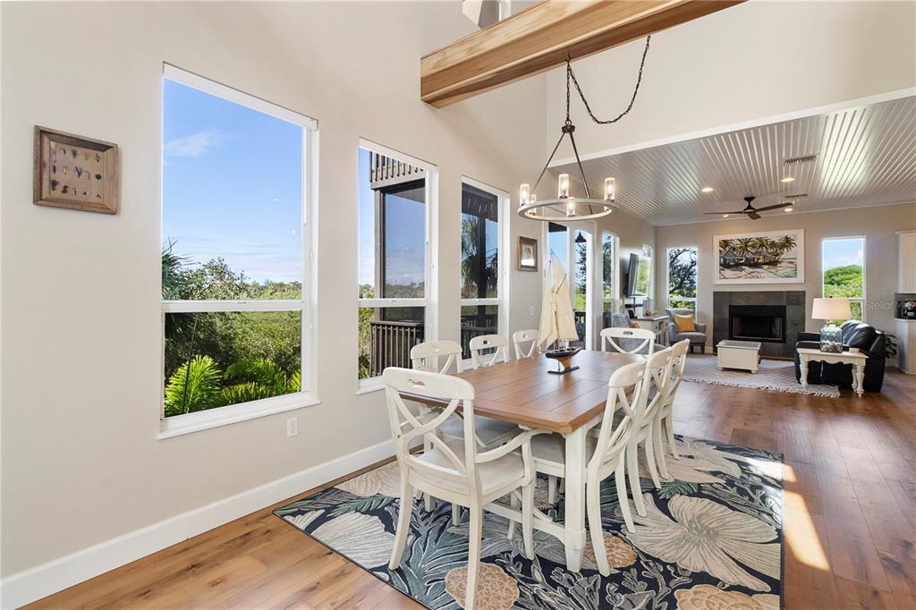 7325 Holly Road Terra Ceia, FL 34250 - Photo 18 of 87 a view of a dining room with furniture window and wooden floor