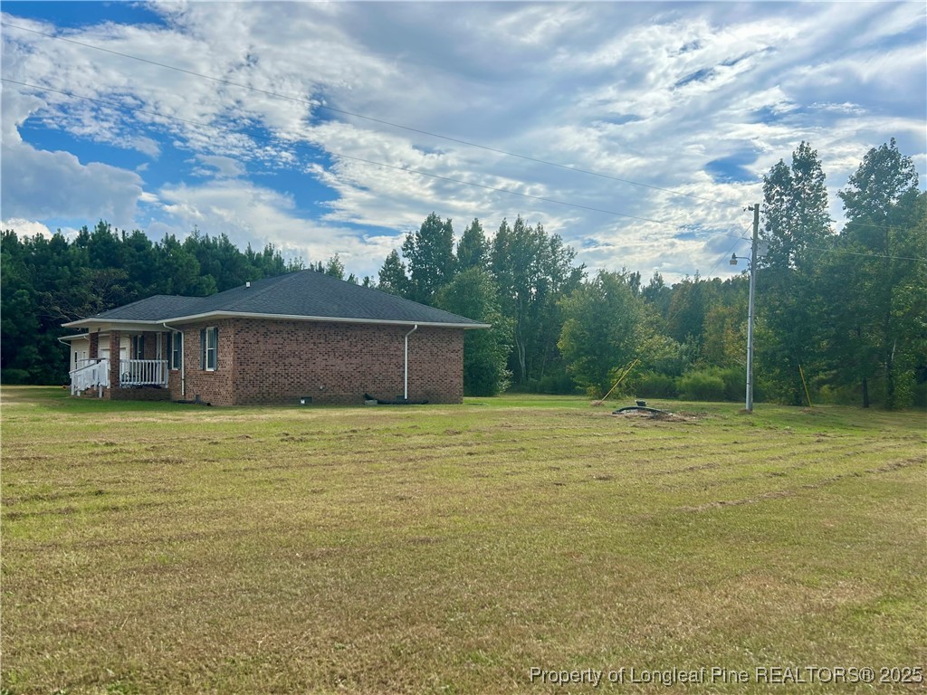 634 Dallas Road Lumberton, NC 28358 - Photo 1 of 27 a front view of a house with a garden