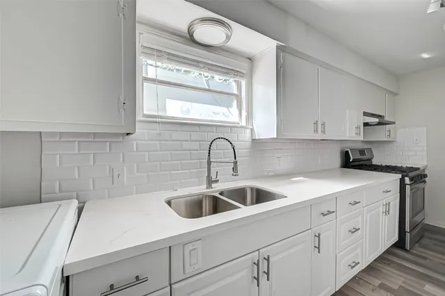 a kitchen with a sink and cabinets