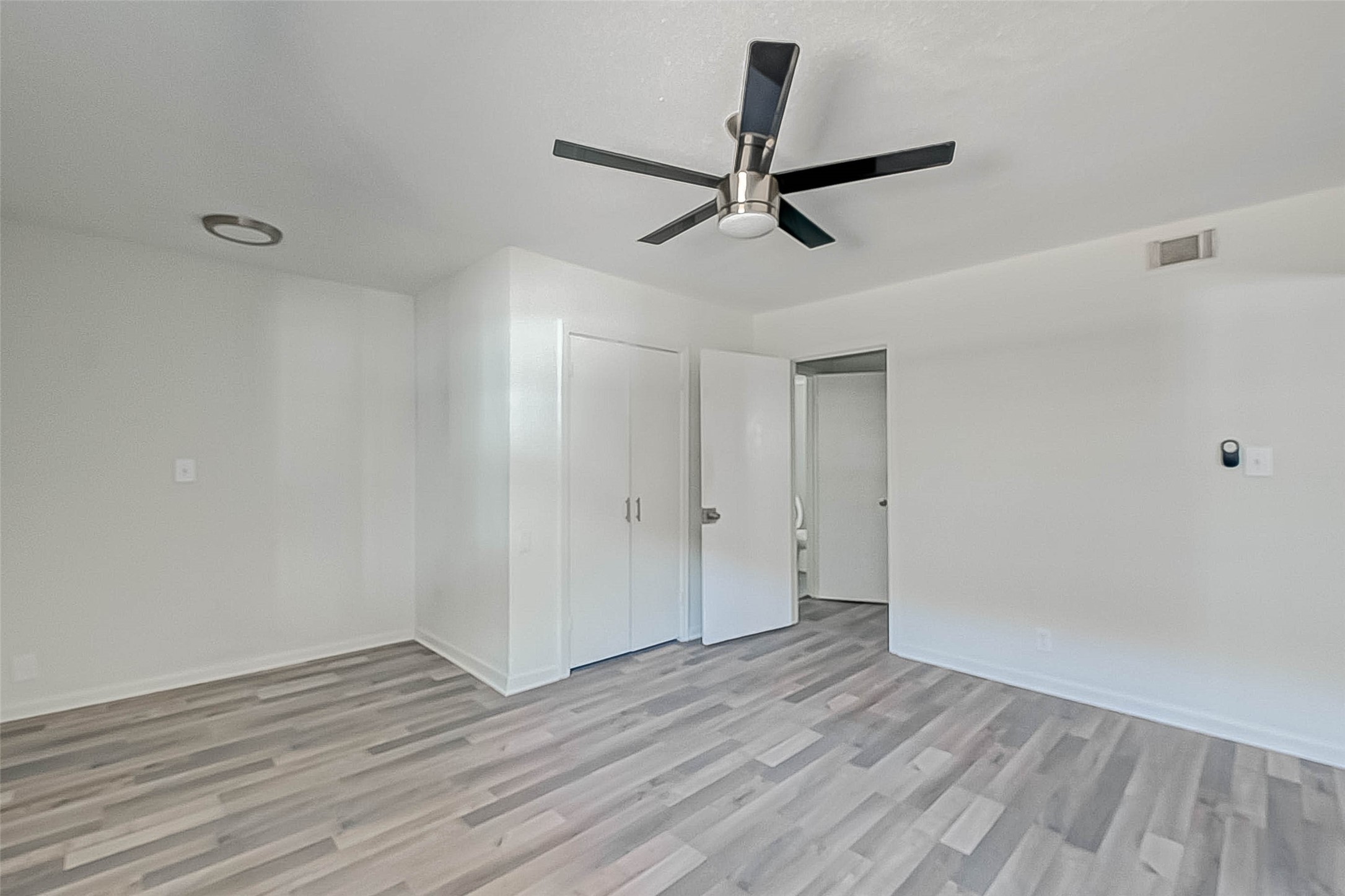 2420 McDuffie Street, Unit 1A Houston, TX 77019 - Photo 9 of 11 a view of a room with wooden floor and white walls