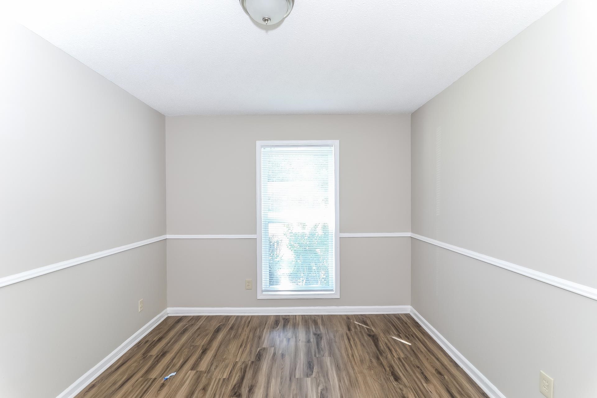 6076 Elk Grove Road Memphis, TN 38115 - Photo 11 of 15 a view of a small space with wooden floor and a window