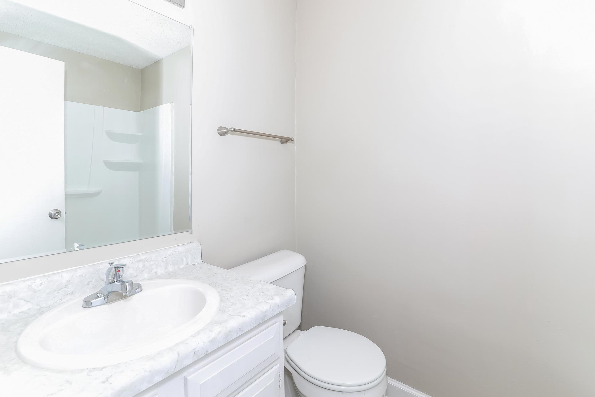 6076 Elk Grove Road Memphis, TN 38115 - Photo 13 of 15 a bathroom with a sink a toilet and mirror