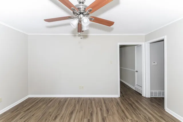 a view of an empty room with wooden floor