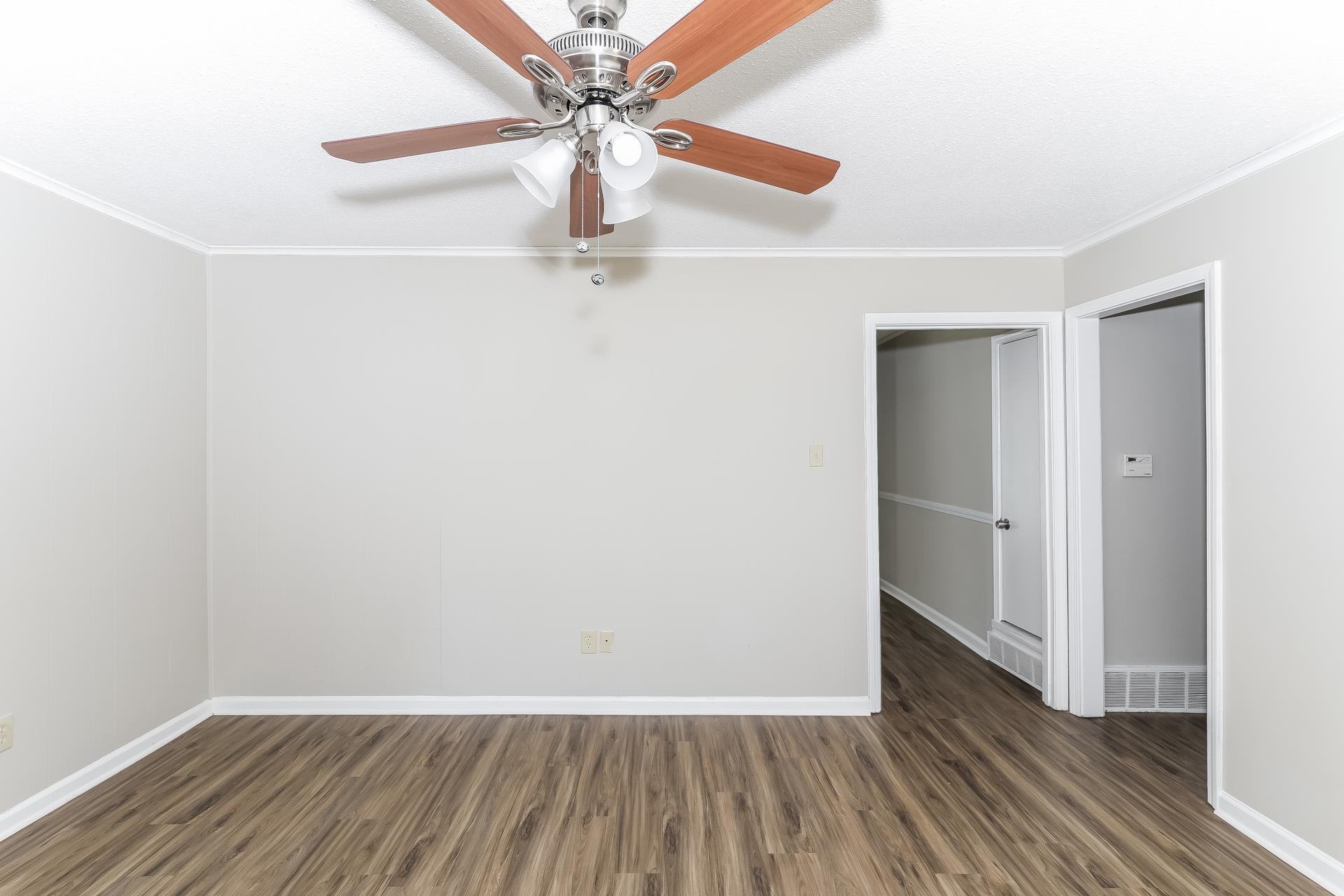 6076 Elk Grove Road Memphis, TN 38115 - Photo 3 of 15 a view of an empty room with wooden floor