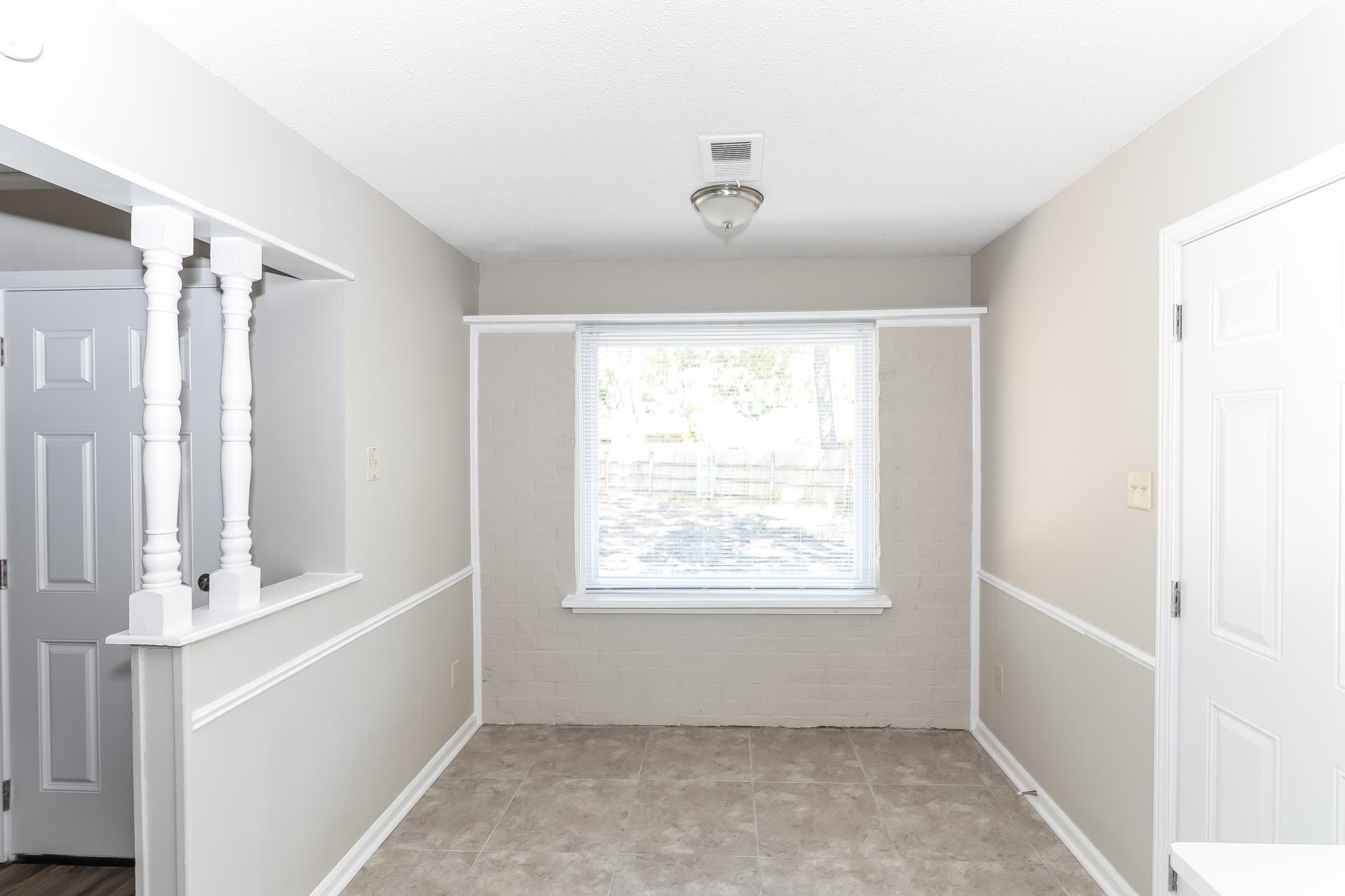 6076 Elk Grove Road Memphis, TN 38115 - Photo 4 of 15 a view of an empty room with a window