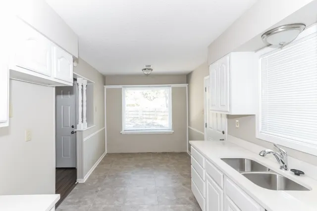 a kitchen with a sink cabinets and window