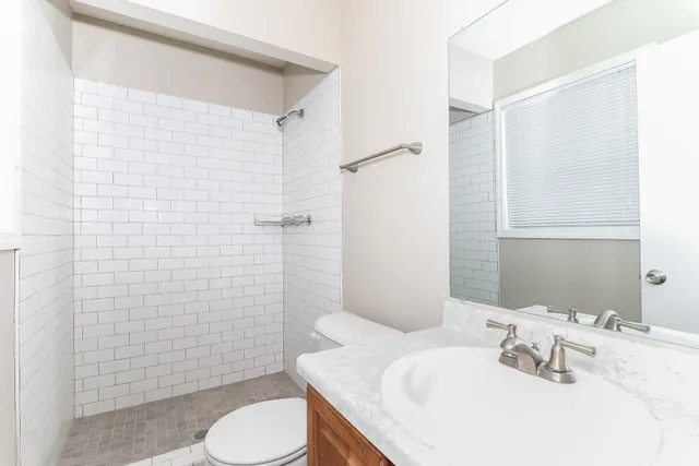 a bathroom with a sink toilet and shower