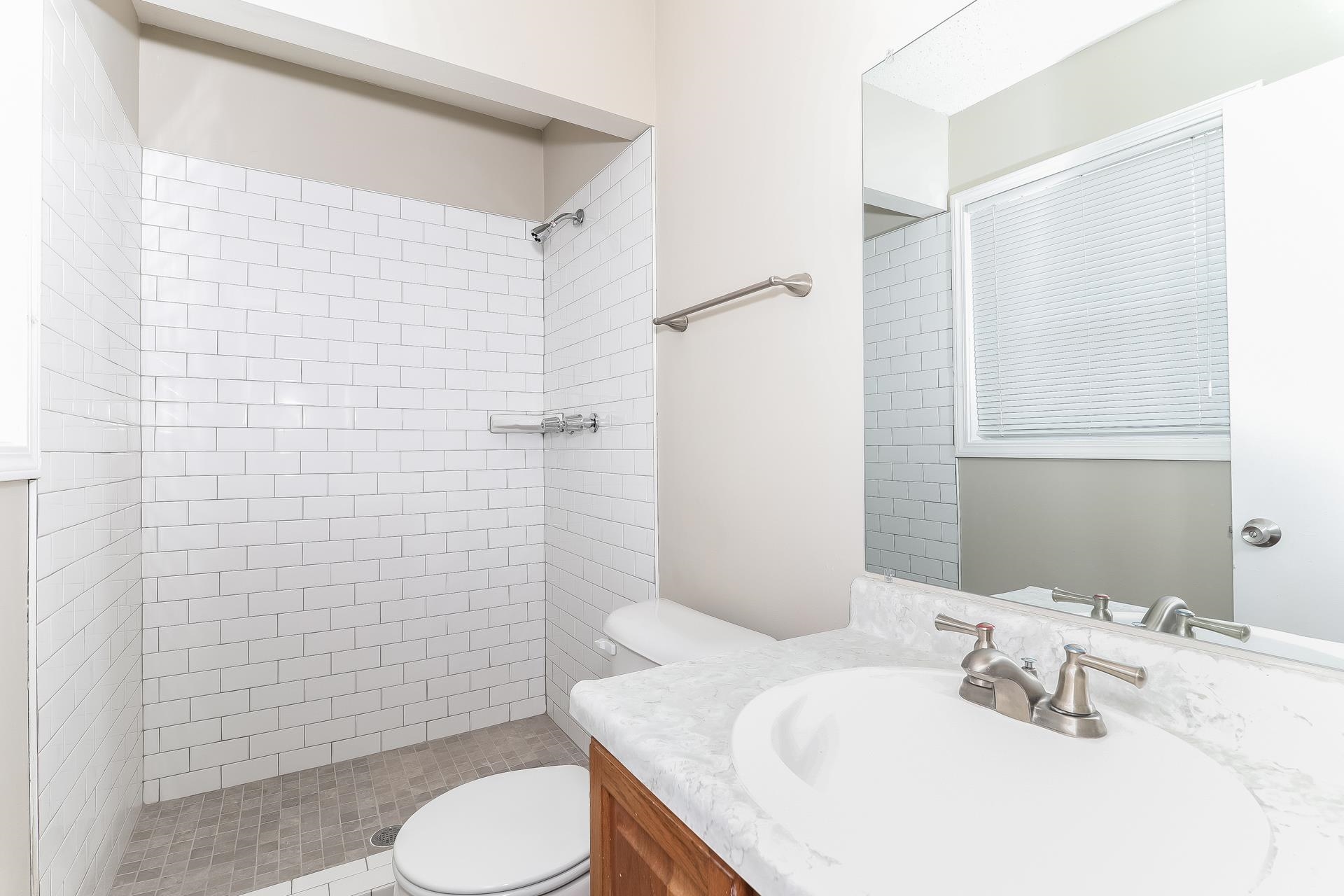 6076 Elk Grove Road Memphis, TN 38115 - Photo 9 of 15 a bathroom with a sink toilet and shower