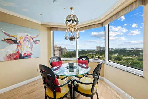 a dining room with furniture a chandelier and wooden floor