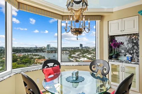 a living room filled with furniture and a floor to ceiling window