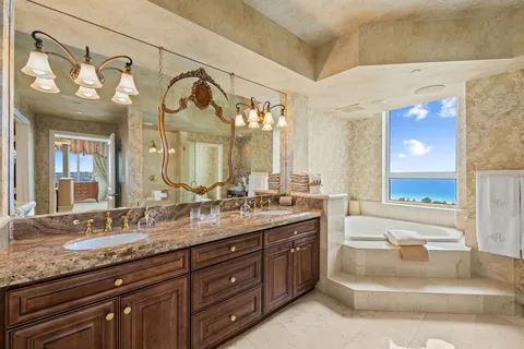 a spacious bathroom with a granite countertop tub sink and a shower