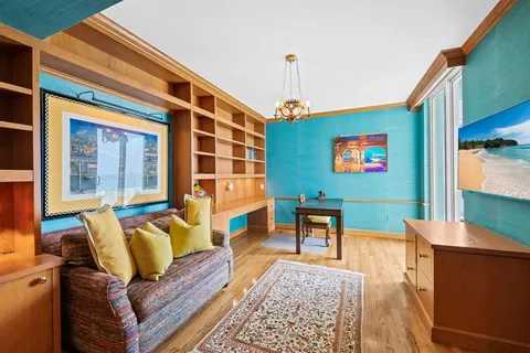 a living room with furniture and a book shelf