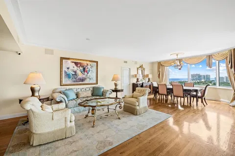 a living room with furniture dining table and a large window