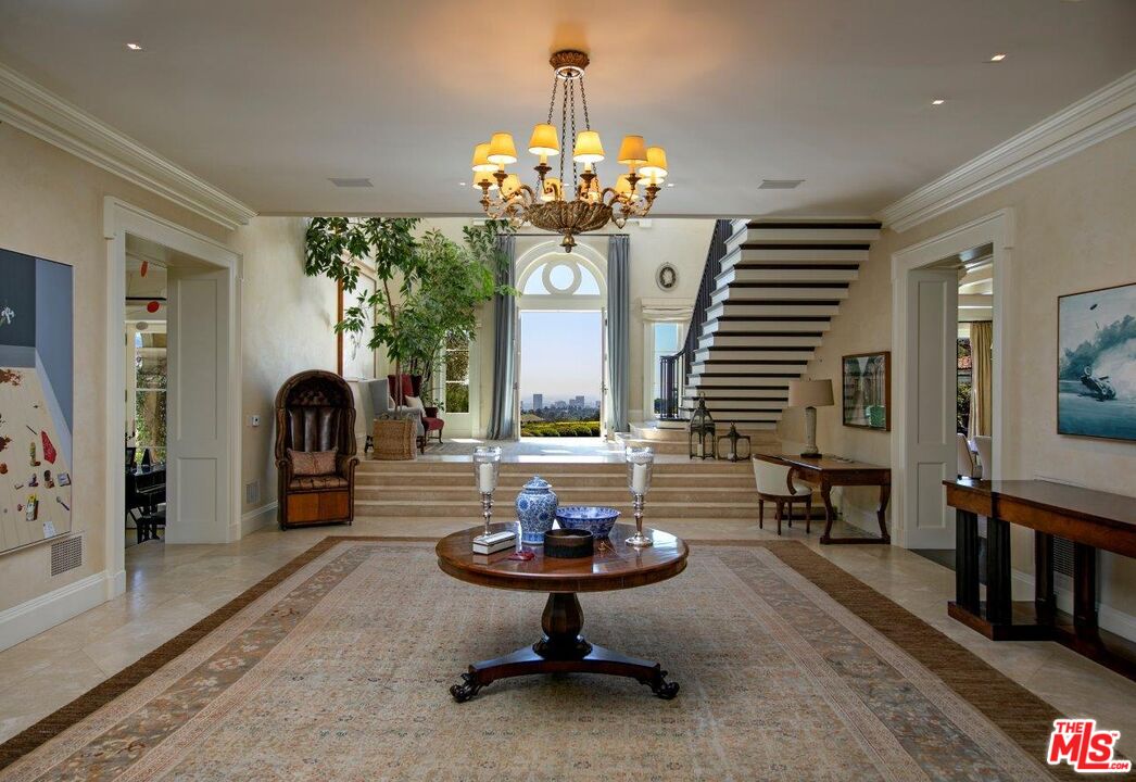 10702 Levico Way Los Angeles, CA 90077 - Photo 11 of 35 a living room with fireplace furniture and a chandelier