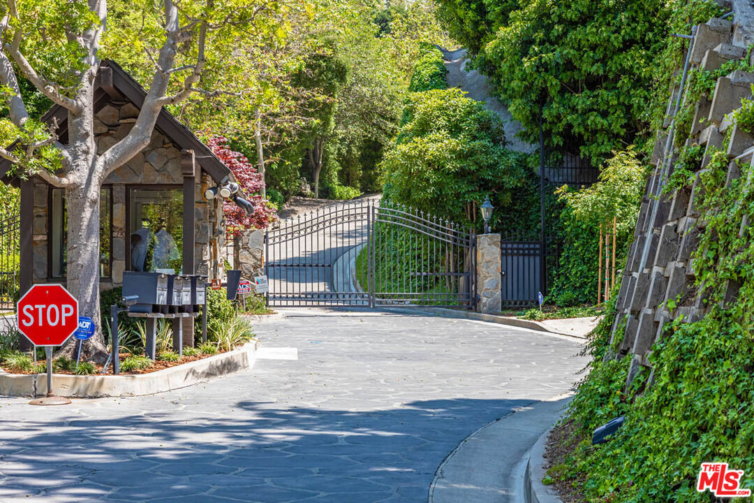 10702 Levico Way Los Angeles, CA 90077 - Photo 3 of 35 a front view of a house with a yard